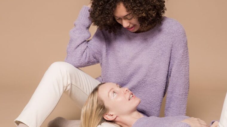 Positive young multiracial girlfriends relaxing after riding penny boards