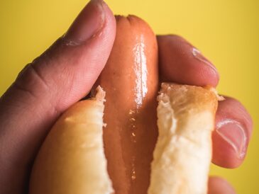 person holding sausage