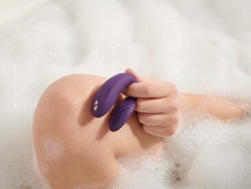 person holding blue plastic hair comb