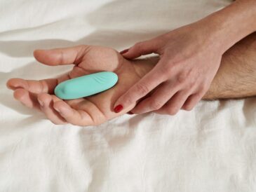 persons hand on white textile