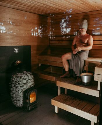 a man sitting in a wooden sauna