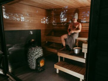 a man sitting in a wooden sauna